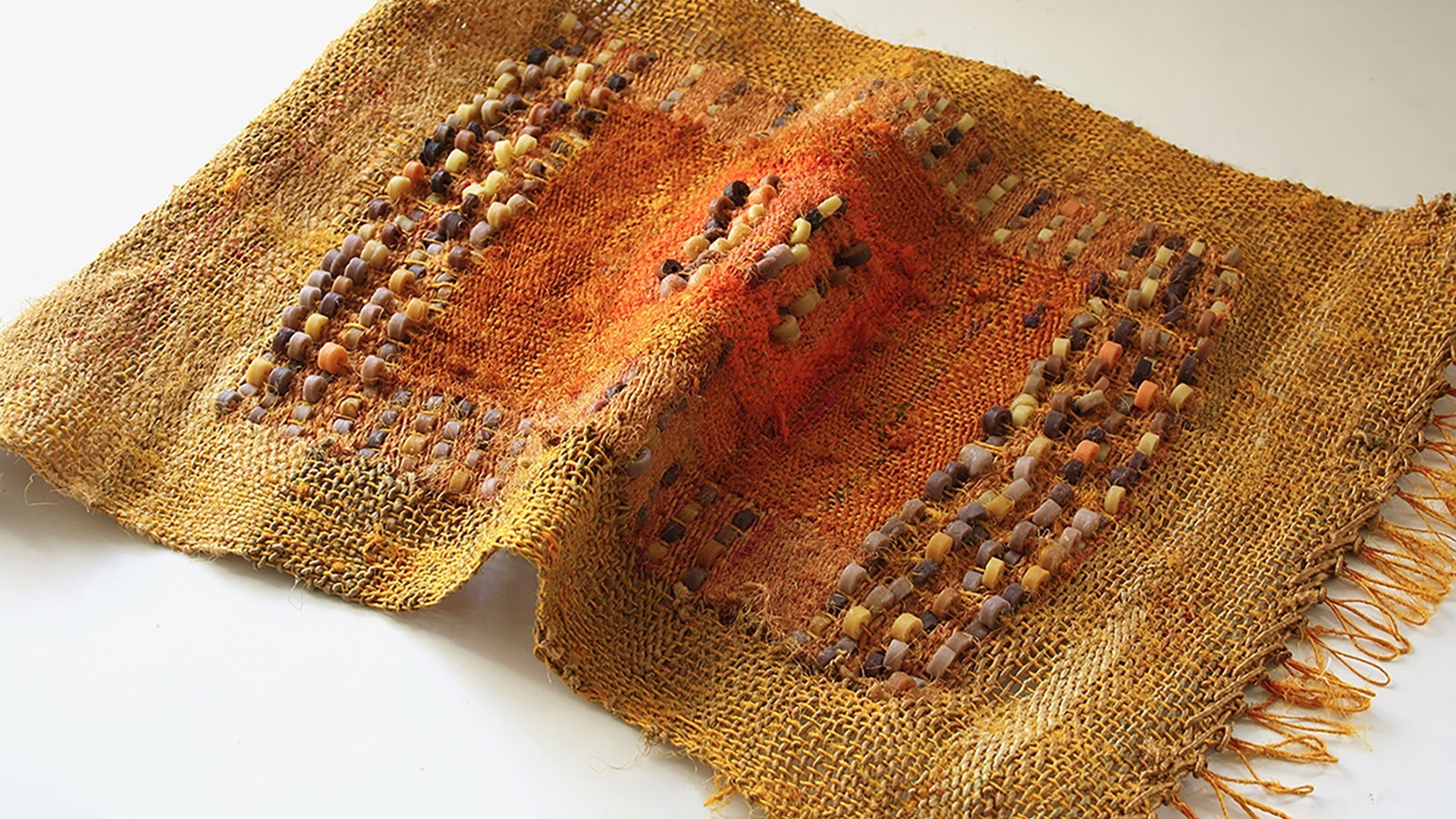Pallavi Padukone, Vetiver III, 2020. 36cm x 51cm (14" x 20"). Hand weaving. Handspun recycled sari silk with vetiver scented wax beads dyed with cutch, turmeric and chilli.