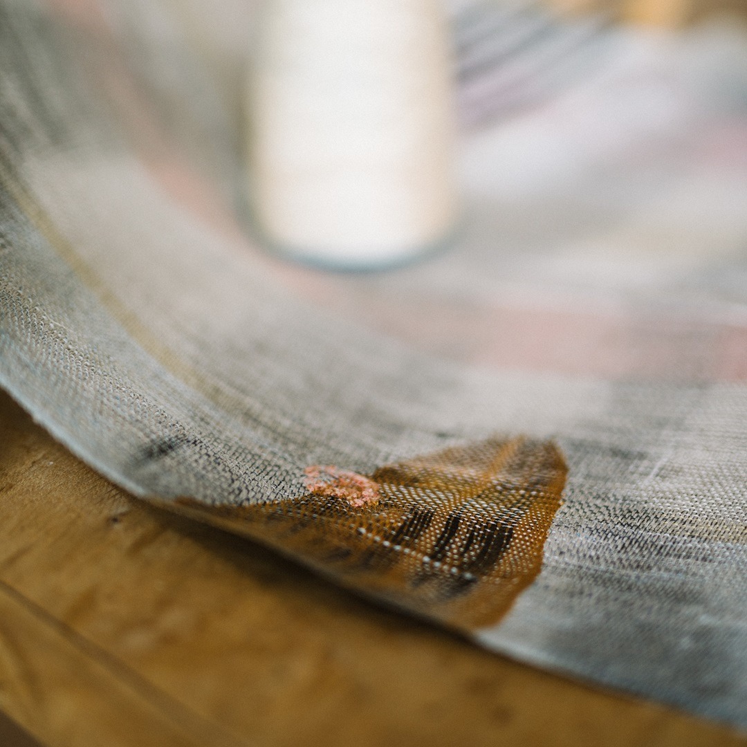 Kate Whitehead, Honesty Two (detail) – Honesty is the Best Policy Series, 2019. 45cm x 100cm (17½" x 39½"). Salvaged grey linen: pink silk warp; gold, orange, pink and black silk weft; pink print section; black, pink and terracotta embroidered detail. Hand weave. Photo: Sarah Mason Photography.