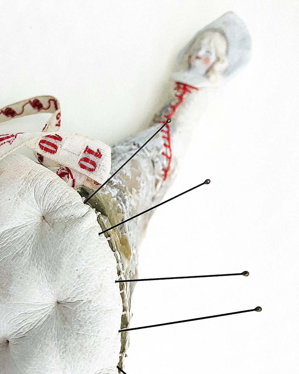 Priscilla Edwards, Stitch and Mend Pretty Lady, 2022. 12cm x 20cm (5" x 8"). Hand stitch, hand manipulated wire. Wire, leather, rayon thread, silk, wax, paint, entomology pins, tape, found objects.