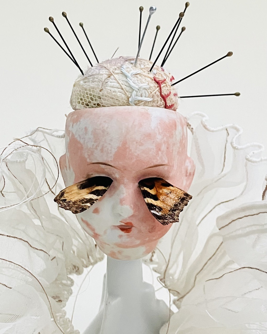 Priscilla Edwards, Mend Me, 2022. 18cm x 13cm (7" x 5"). Hand and machine stitch, hand manipulated wire. Wire, rayon thread, cotton threads, entomology pins, silk, lace net, found objects, butterfly wings.