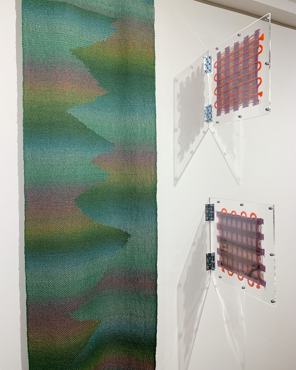 Left: Johanna Norry, Sapelo Dreams: Asleep in a Live Oak, 2023. 43cm x 152cm (17" x 60"). Hand weaving. Cotton and wool yarn. Right: Amanda Britton, Hereditary Smoker Series, 2023, 30cm x 30cm (12" x 12") each. Digital printing, weaving. Digitally printed vellum, plexiglass, cotton yarn, wool roving.
