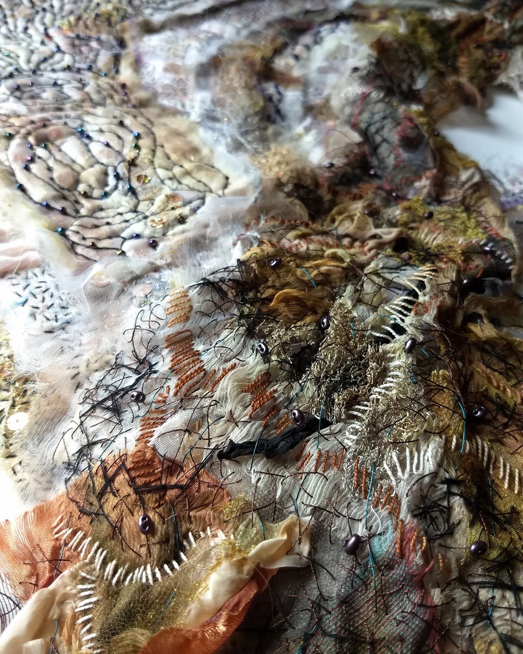 Olga Teksheva, If Rocks Were Looking For Identity, 2021. 83cm x 77cm x 5cm (33" x 30" x 2"). Hand embroidery, textile collage. Felt base, wooden reinforcement structure, recycled paper, beading, brocade, chiffon, metal wire.