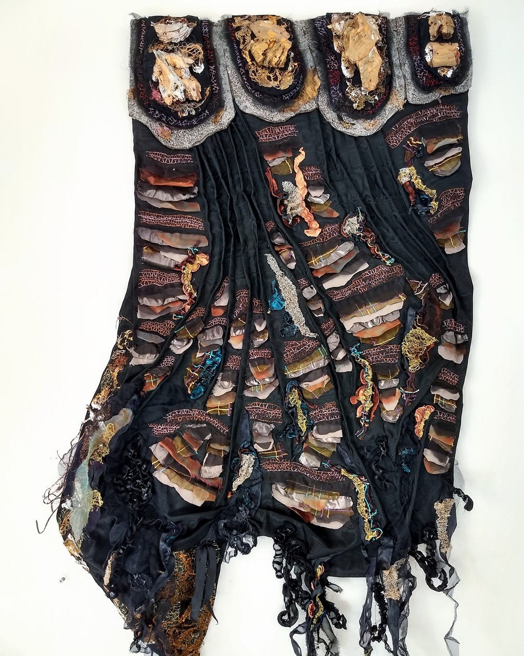 Olga Teksheva, Realm on Rocks: Fauno the Wolf, 2021. 78cm x 140cm x 10cm (31" x 55" x 4"). Hand embroidery, textile collage. Felt base, wooden reinforcement structure, cotton, chiffon, silk, recycled plastic, wood fragments, acrylic paint, metallic lace.