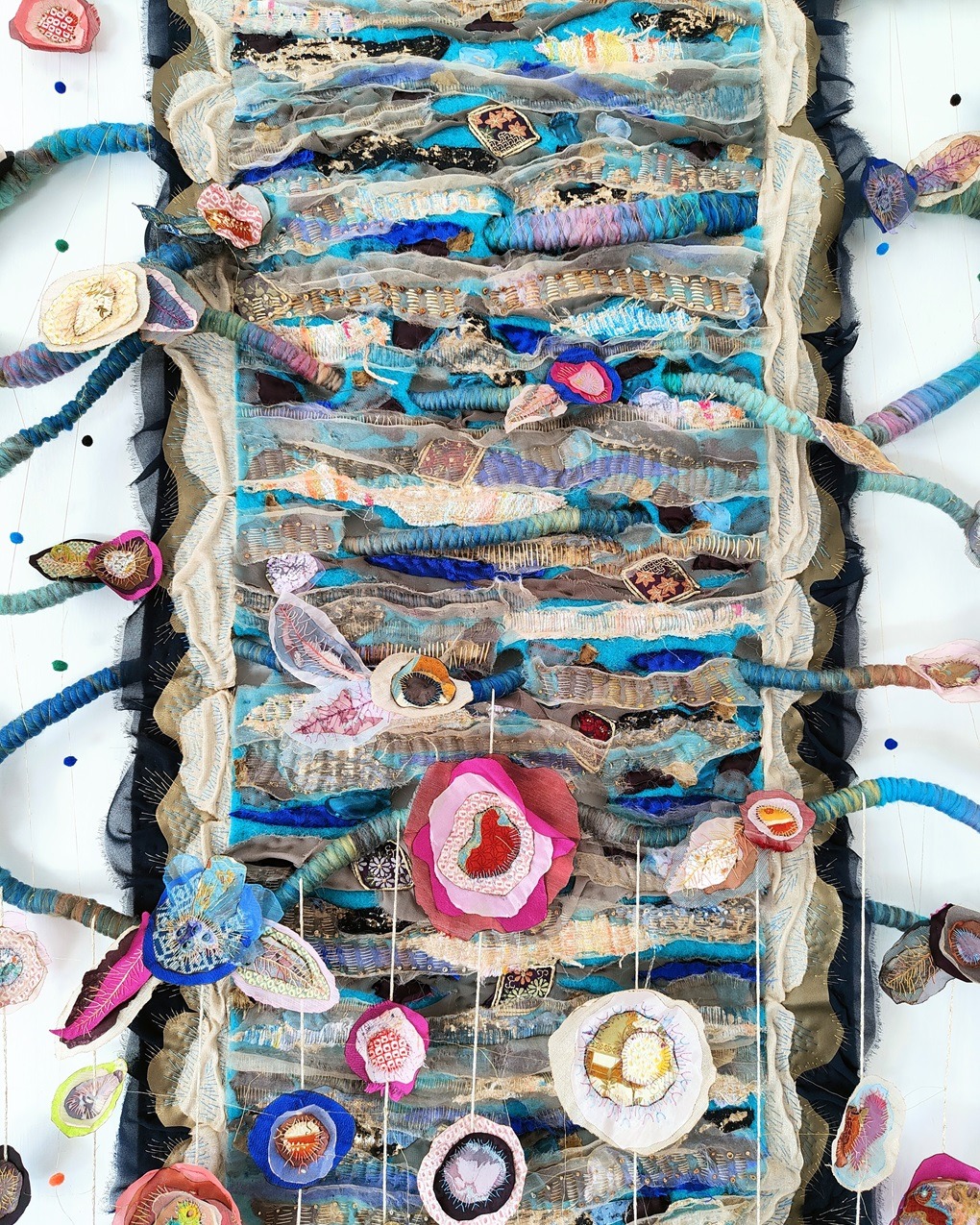 Olga Teksheva, Realm On Rocks: Terminus (detail), 2023. 90cm x 250cm x 7cm (35" x 98" x 3"). Hand embroidery, textile collage. Felt base, wooden reinforcement structure, woollen cords, wool fibres, fake leather, silk, chiffon, Japanese vintage fabrics.