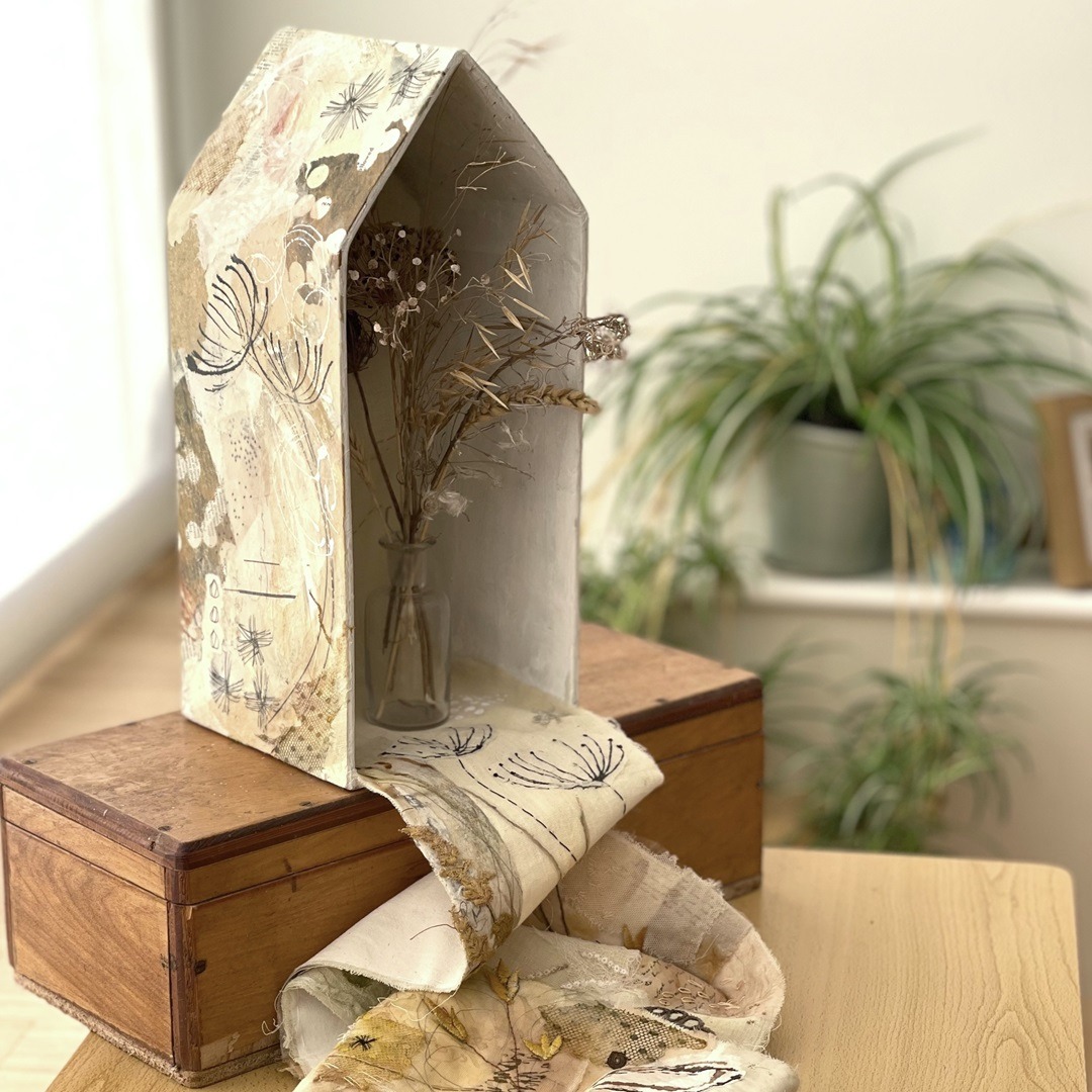 Rachael Singleton, Seed-head House, 2019. House: 14cm x 30cm (6" x 12"). Fabric: 1.4m x 11cm (55" x 4"). Hand stitch, collage, distressing. Wet-strength papers, natural fabrics, encaustic wax medium, grey-board, vintage lace fragments.