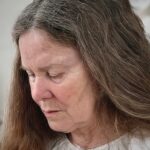 Close up of Anita Bell with a contemplative expression.