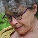 A close up image of textile artist Cheryl Rezendes working in her studio.