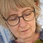 A close up image of textile artist Emily Jo Gibbs working in her studio.