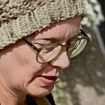 A close up image of textile artist Letitia Thompson working on her work.