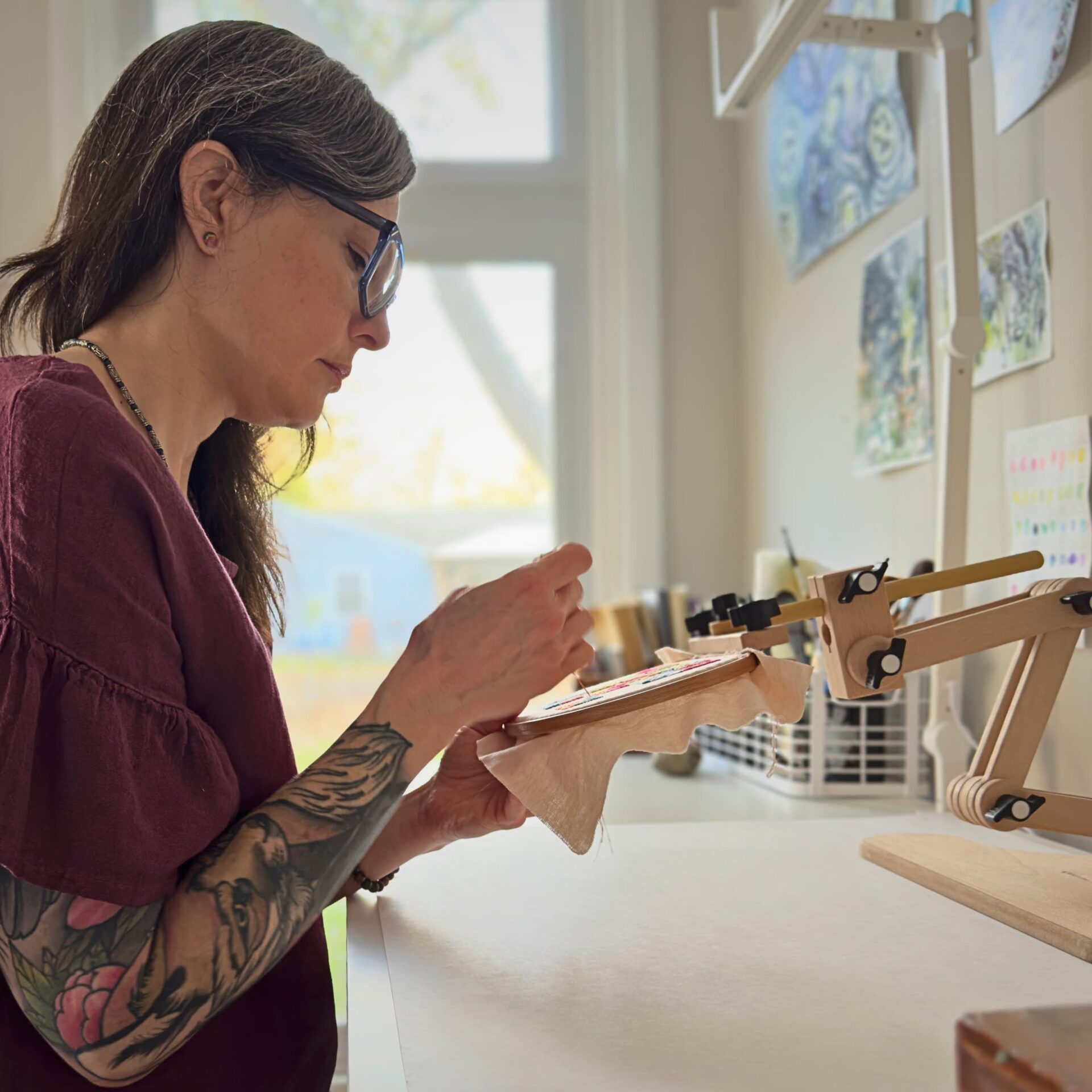 Heather Kerley working in her studio at a workspace.