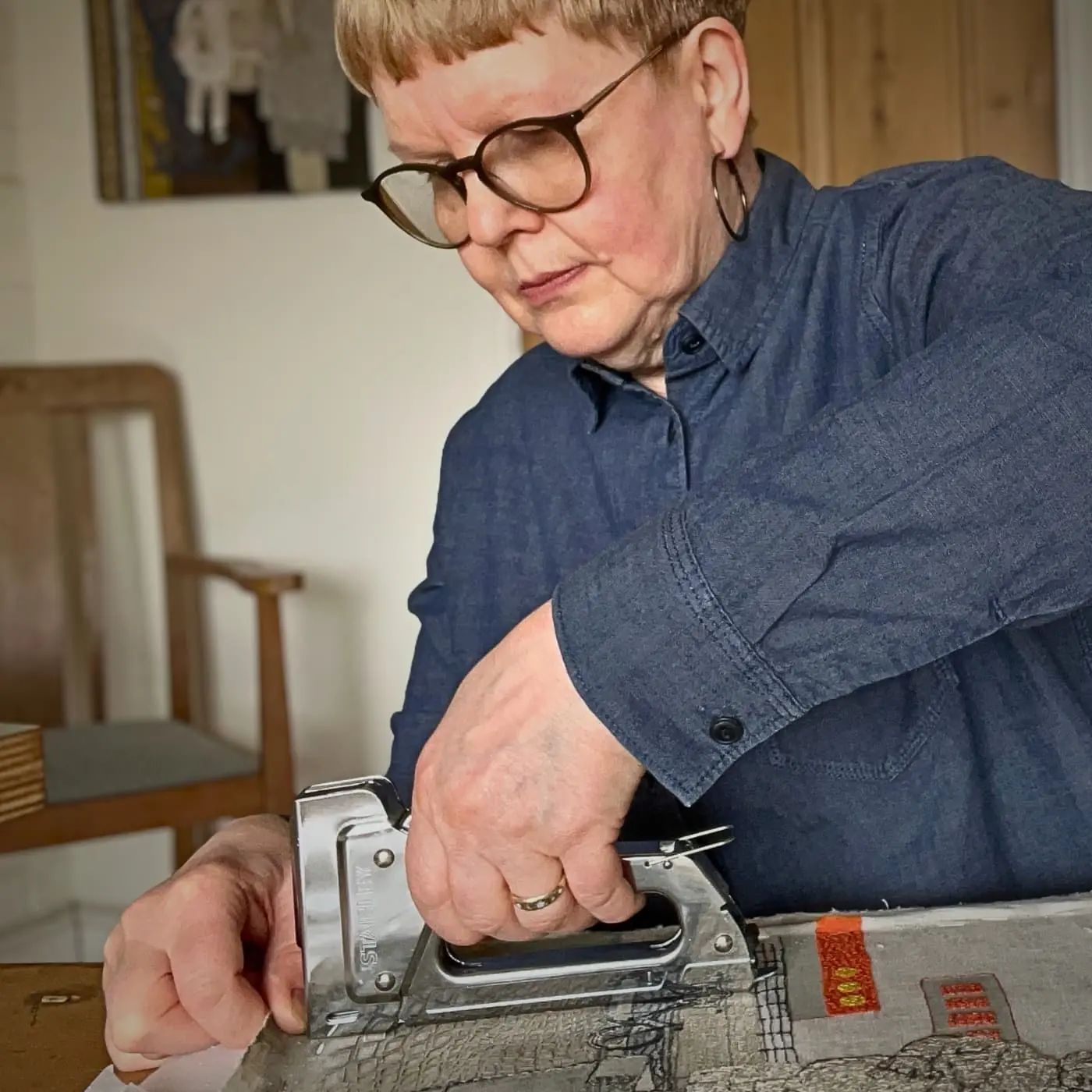 Artist Sue Stone using a tool for creation.