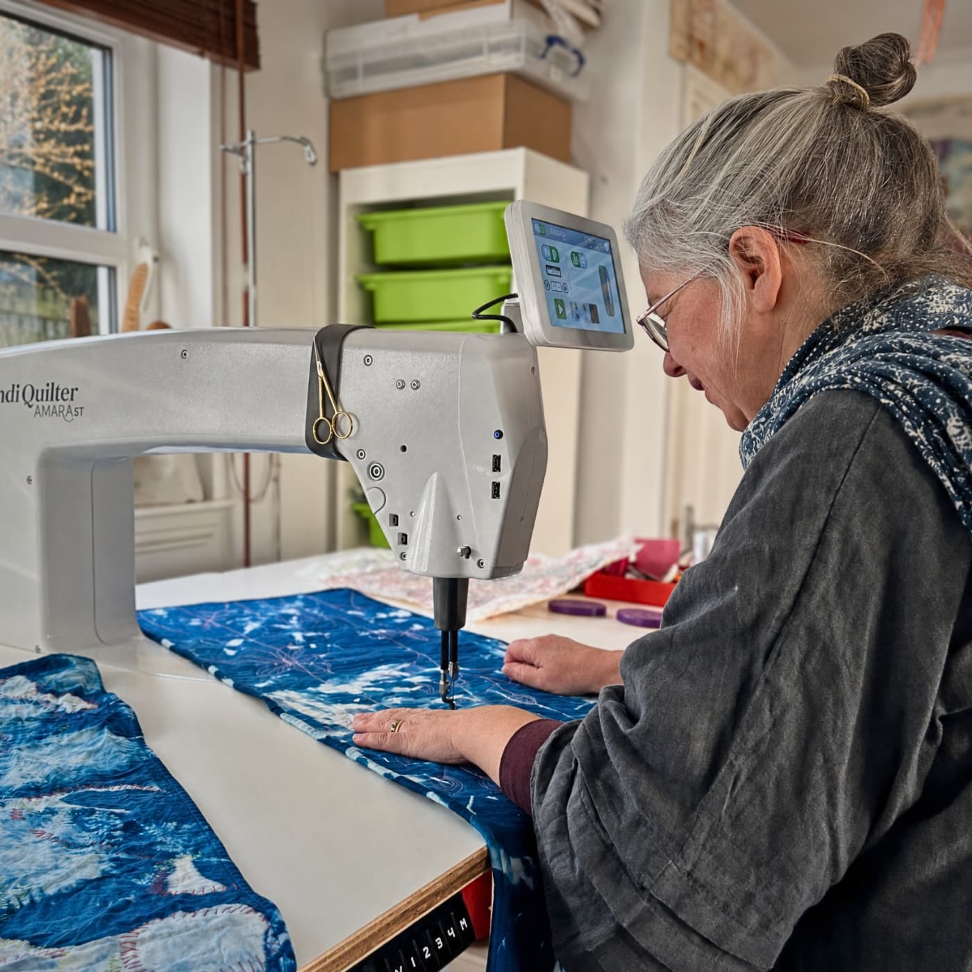Textile Artist Gillian Cooper quilting with a sewing machine.