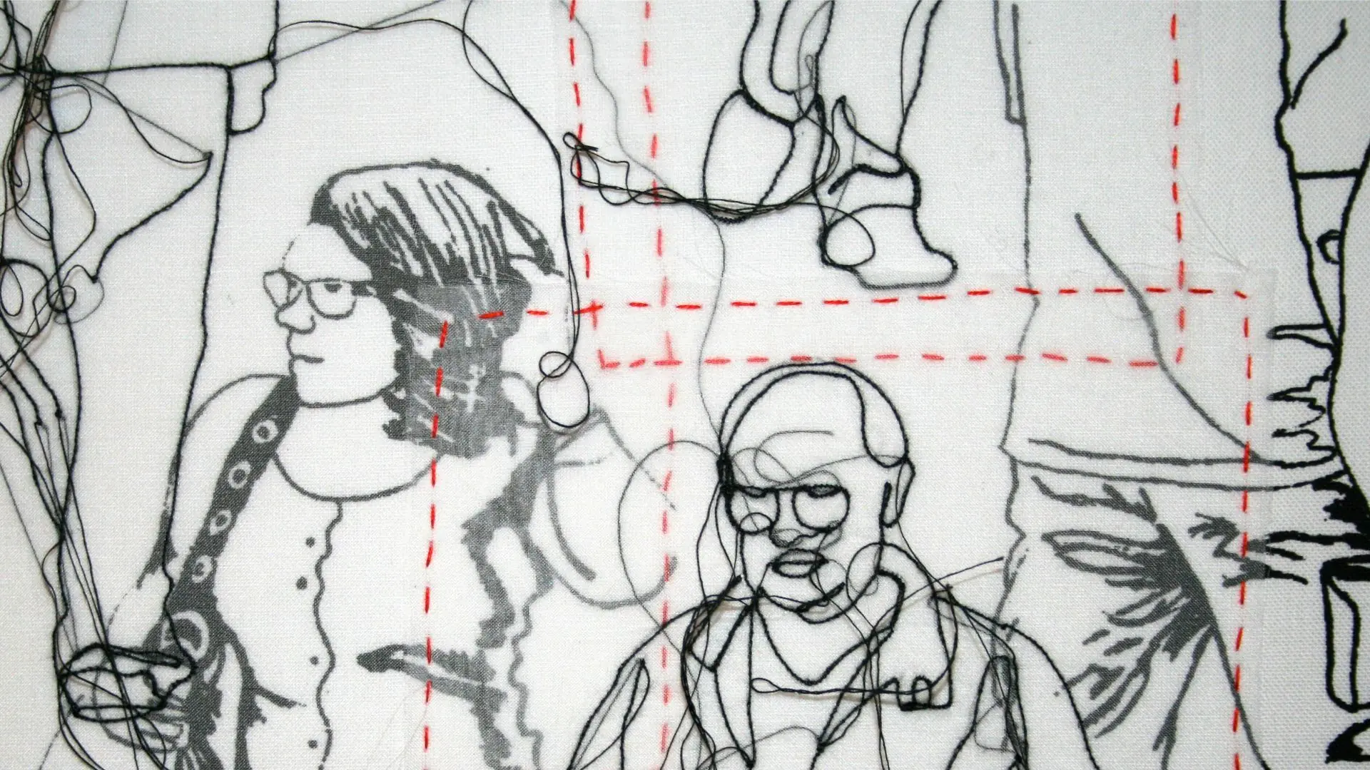 Close-up detail of a fabric artwork with everyday people stitched in black, white and red