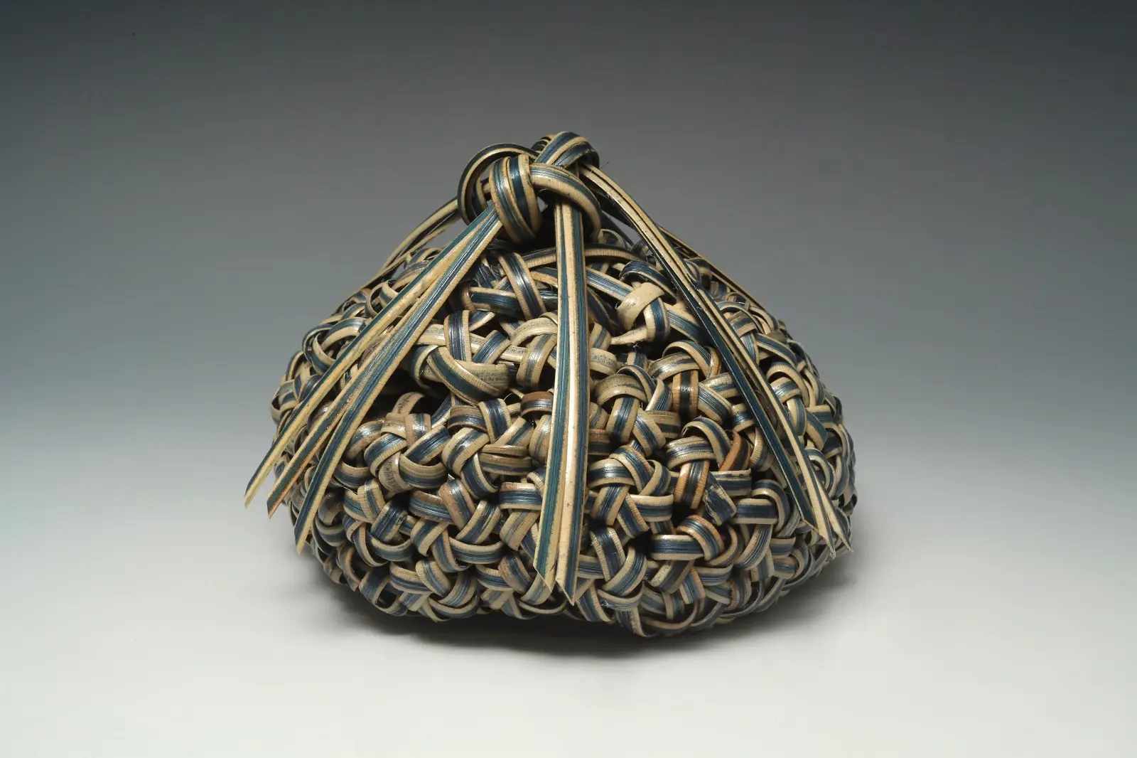 Barbara Shapiro: What Knot: Top Knot, 2018, 7 x 7 x 4.5”, indigo dyed sedori cane, Japanese Flower Knot plaiting on a Hemp leaf plaited base.