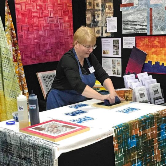 Leah Higgins demonstrating printing techniques at The Scottish Quilting Show in Glasgow.
