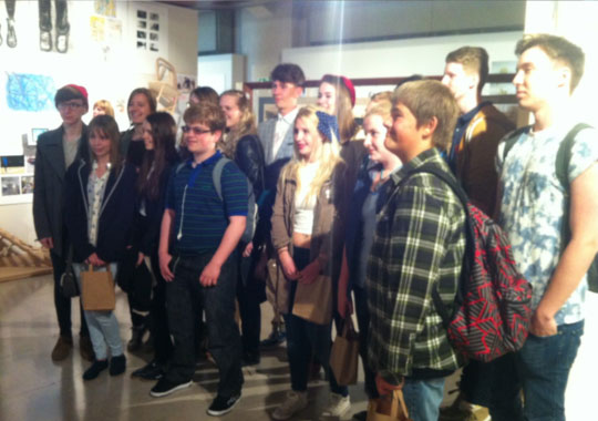 Saturday club members stood with their textile work at Somerset House
