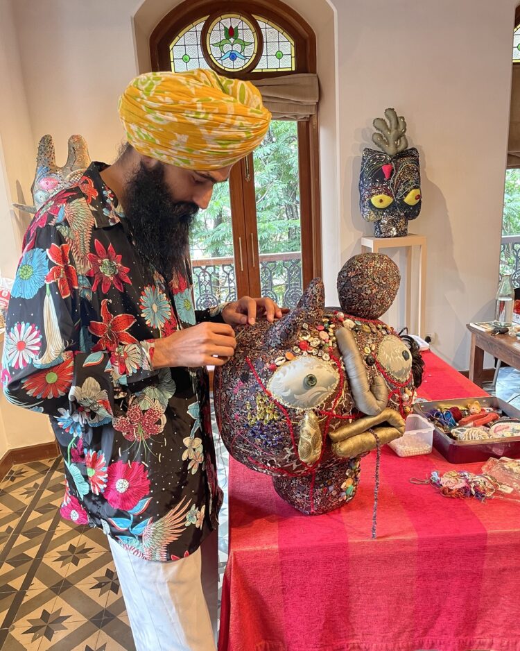 Gurjeet Singh stitching the final details on his artwork Portrait of Lakhi in his studio.