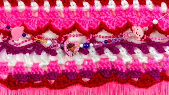 Hale Ekinci, Pinky Promise (detail), 2022. 43cm x 66cm (17” x 26”). Screenprinting, embroidery, crochet, sewing, beading. Screenprint, embroidery floss, glass beads, thread, sequins, interfacing, yarn crochet on found handkerchief.