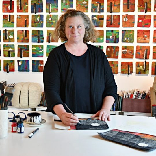 Fiona Duthie in her studio with Chromatic Navigation on the wall
