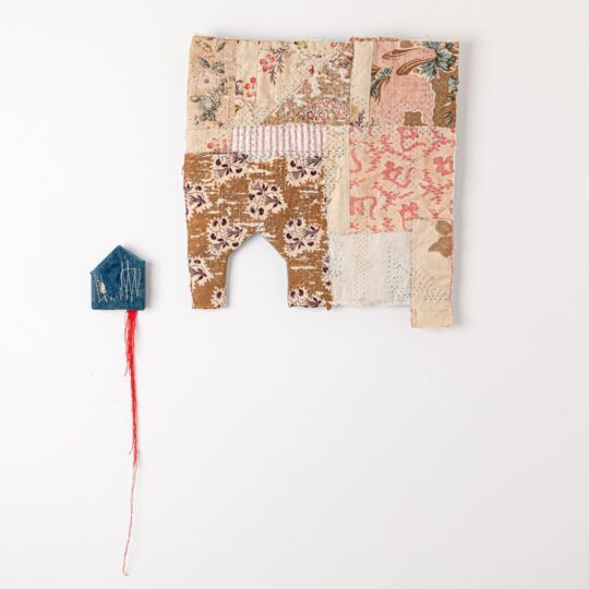 Hannah Lamb, At Home, 2021. 47cm x 70cm x 2.5cm (18½" x 27" x 1"). Hand stitch, quilting and construction techniques. Vintage cotton and linen fabrics, thread and wood. Photo: Proud Fox