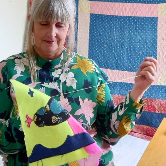 Harriett Chapman stitching in her workshop space.