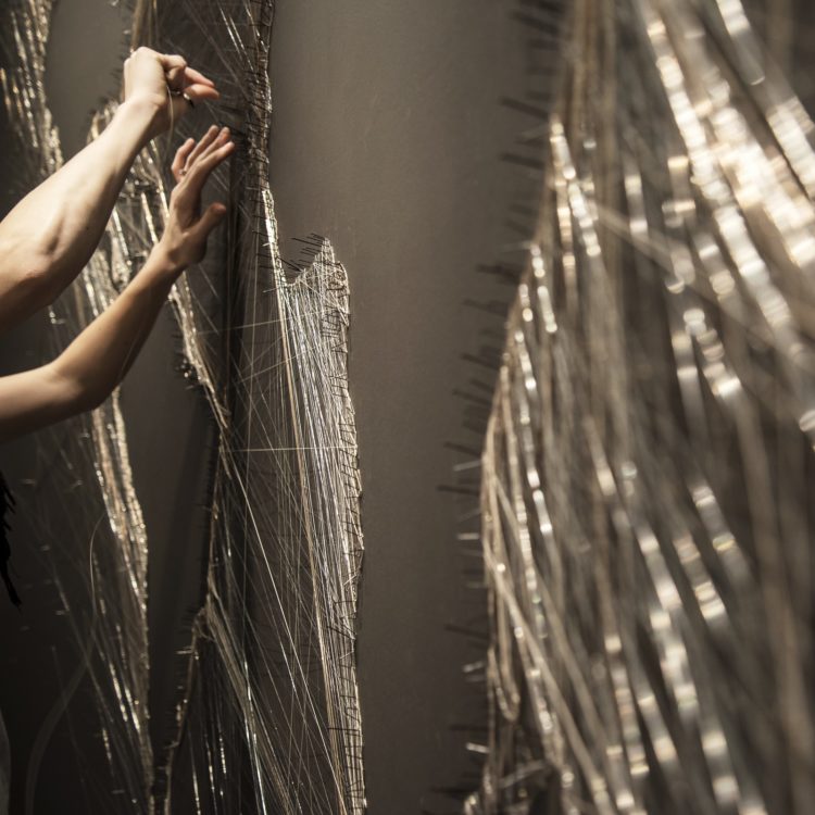 Debbie Smyth installing Le Méridien Map in the foyer of Le Méridien, Hamburg, 2015. 3m x 4m (9' 10” x 13' 1”). Pins and thread. Photography: Zac Mead