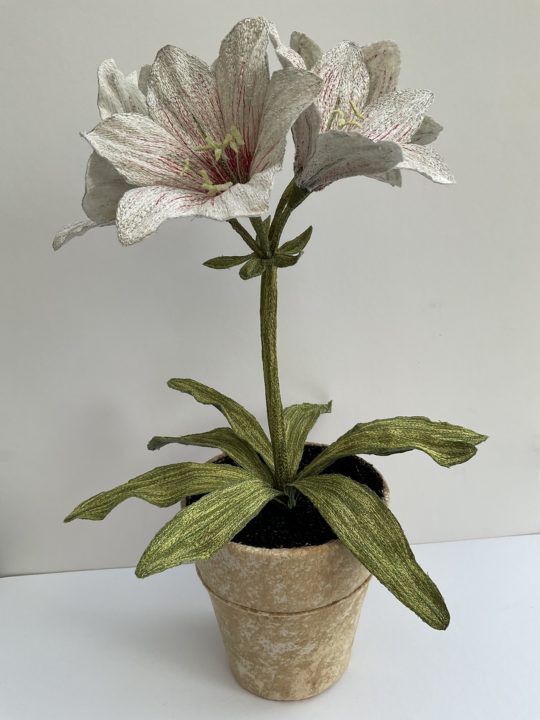 Corinne Young, Amaryllis Pot Plant at Bonadea, London, 2021. 40cm (16”) tall. Machine stitch. Madeira threads, net, textile medium, florist’s wire/tape and flax fibres.