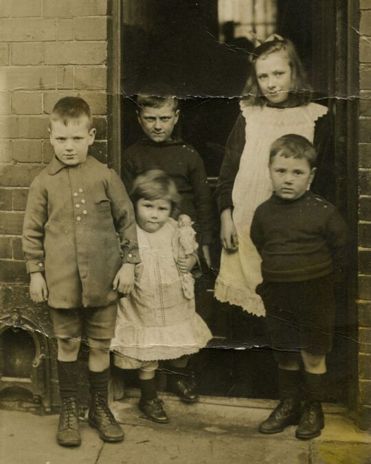Original photograph of children in a doorway from Sue Stone's family album