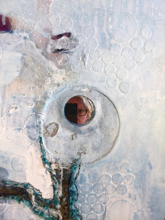 Detail with selfie in mirror, pieces of textile, sawdust, ink, poppy seed pods, homemade paint