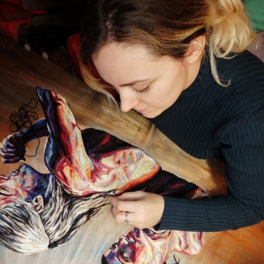 Julie Sarloutte working on an embroidery.