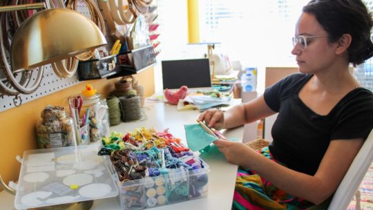Megan Zaniewski, working on a moth embroidery in her home studio