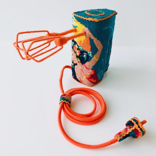 Ulla-Stina Wikander, Electric Mixer, 2019. 25cm x 10cm x 20cm (10" x 4" x 8"). Mixed media. Found embroidery, ricrac, electric mixer.