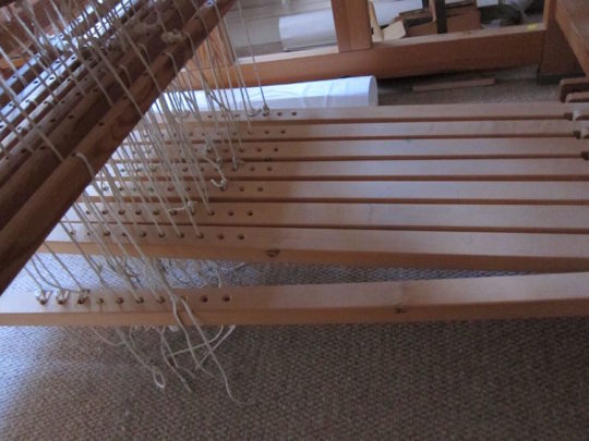 Tying the peddles on the floor loom