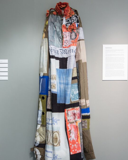 Nigel Cheney, Corporal William Holman, 2017. 60cm x 200cm (23½" x 78¾"). Artwork as originally shown in the first Decorated exhibition, Sleaford. Digital and transfer print, digital guipure lace, hand and machine embroidery. Adapted army uniform with appliquéd vintage and digitally printed fabrics.