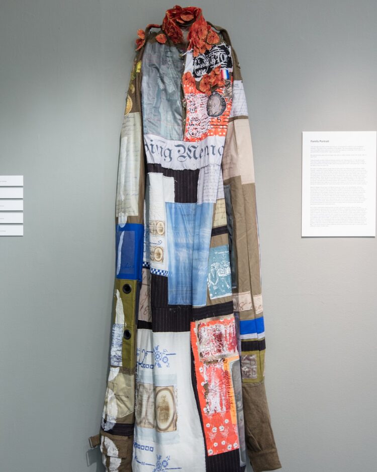 Nigel Cheney, Corporal William Holman, 2017. 60cm x 200cm (23½" x 78¾"). Artwork as originally shown in the first Decorated exhibition, Sleaford. Digital and transfer print, digital guipure lace, hand and machine embroidery. Adapted army uniform with appliquéd vintage and digitally printed fabrics.
