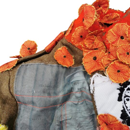 Nigel Cheney, Corporal William Holman (detail), 2022. 60cm x 200cm (23½" x 78¾"). Digital and transfer print, hand and machine embroidery, with orange poppies stitched using a Brother computerised machine. Adapted army uniform with appliquéd taffeta, cotton, wool, vintage and digitally printed fabrics.