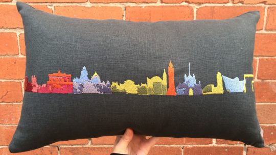 Deborah Toner, Multicoloured Belfast Skyline on Dark Grey Linen, 2014. 50cm x 30cm (20” x 12”). Machine embroidered. Irish linen.