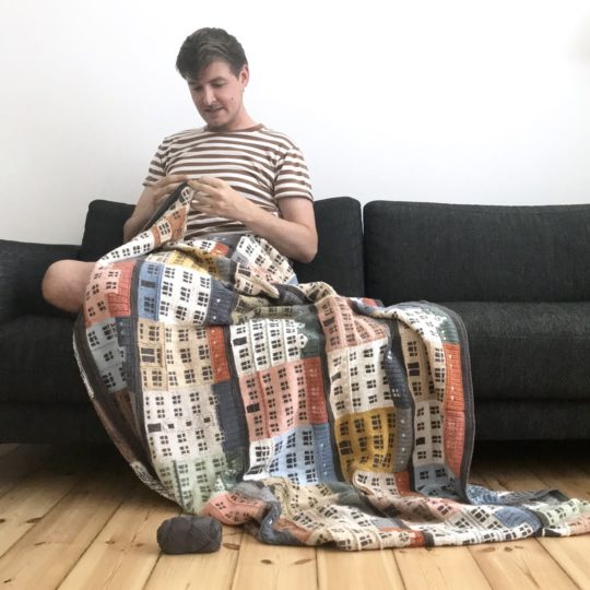 Jake Henzler adding the crochet border to Copenhagen Building Blocks.