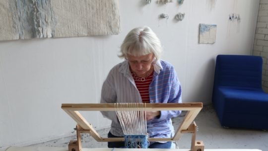 Fiona Hutchison weaving on a small frame loom. Photo: Norman McBeath