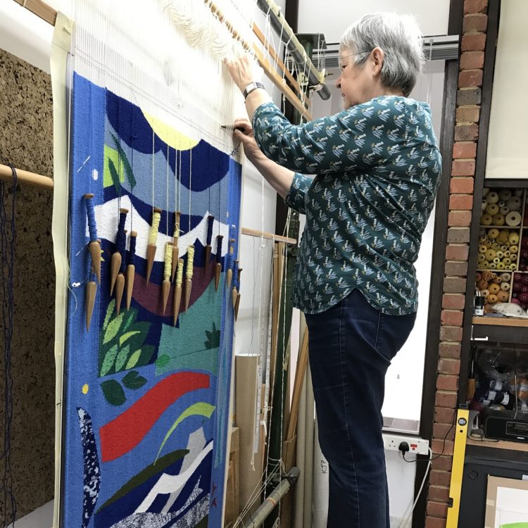 Jeni weaving the Linden Tapestry in her studio.