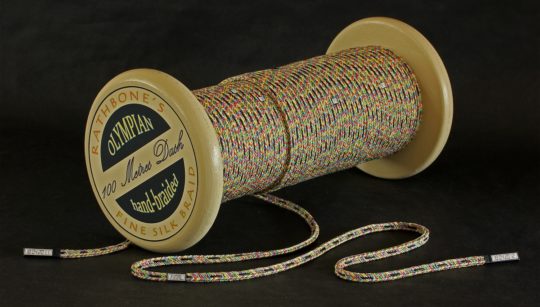 Marilyn Rathbone: 100 Metres Dash, 2011-12, hand-dyed Como silk, painted wooden reel, black card / Inkle weaving