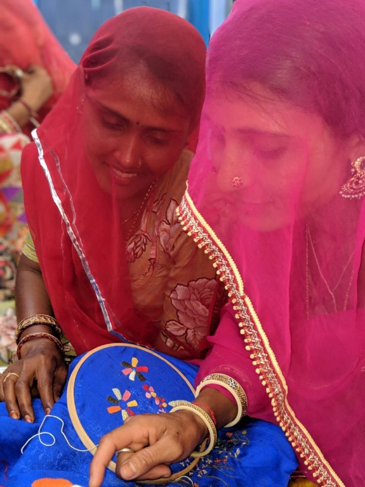Saheli Women: Kanta (in red) and Bhawari (in pink) working the embroidery detail