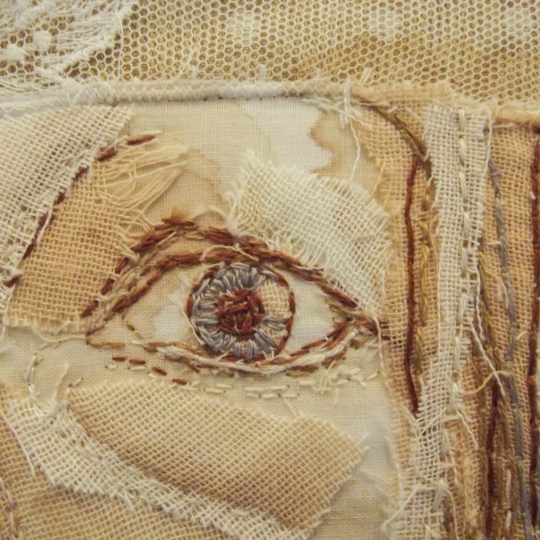 Bridget Steel-Jessop, Self-portrait (detail), 2016. 20cm x 20cm (8" x 8"). Raw edge appliqué, layering fabrics and cutting back, tea staining, hand embroidery. Linen and cotton mix backing fabric, recycled fabrics, muslin, embroidery threads.