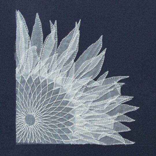 Bridget Steel-Jessop, Sunflower, 2022. 30cm x 30cm (12" x 12"). Manipulated silk organza with hand embroidery, blanket stitch. Black cotton backing fabric, silk organza, sewing cotton.