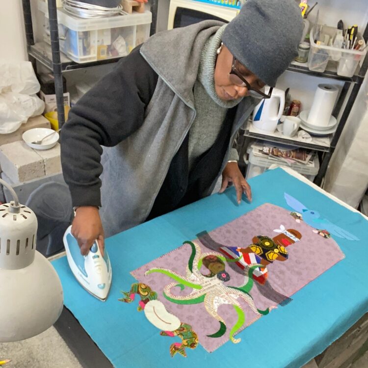 Marcia Bennett-Male preps her work for stretching in her studio.