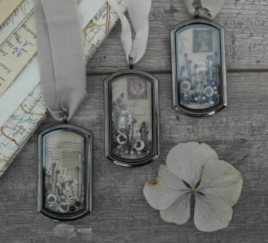 Anne Brooke: Pendants Printed postcard fragment (2020), 4cm x 2cm, hand stitch mini linen button silk ribbon