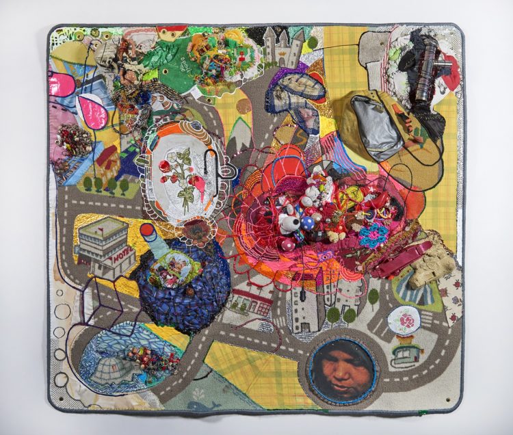 Julie Peppito: Crawling on Cancer (The Teflon Toxin by Sharon Lerner), 2016, 52" x 55" x 6", Carpet, trim, photo, thread, found objects, fabric paint, fabric, grommets Photo credit: Dan Gottesman.