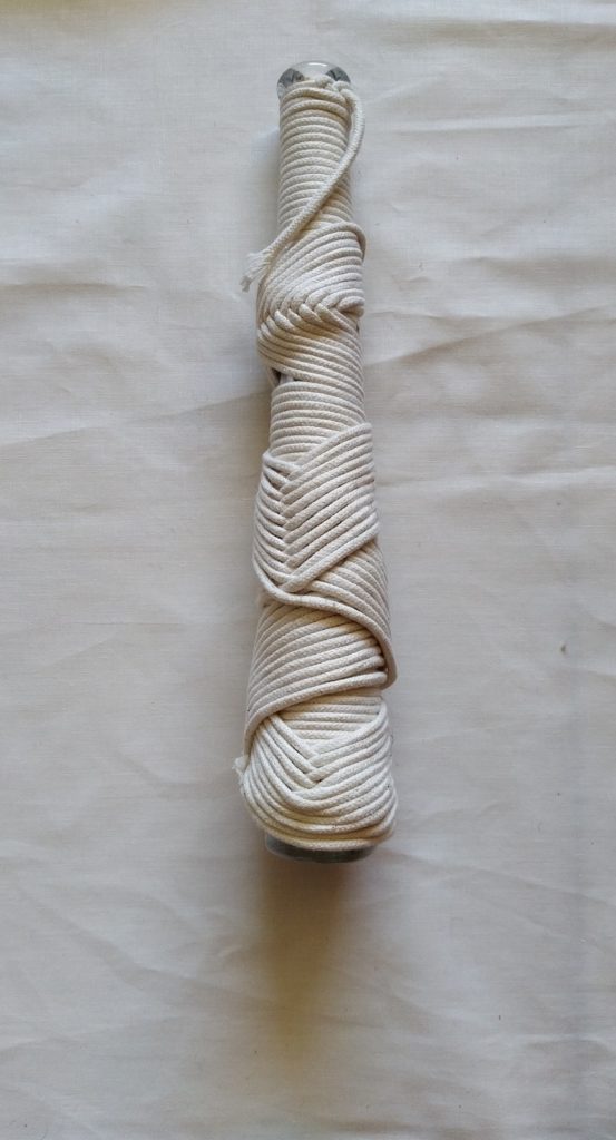 Mauréna Lambert: Bottle line, 2014, 31 x 8, Cotton yarn roll on a glass bottle