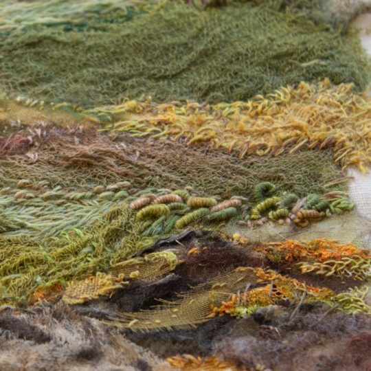 Heidi Ingram, Killin by Loch Tay (detail), work in progress, 2022. 18cm x 18cm (7" x 7"). Hand stitch, paint, collage. Stranded cotton threads, linen fabric, paint.