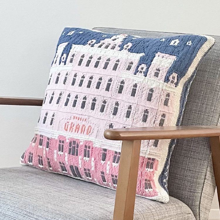 Jake Henzler, The Grand Hotel Cushion, 2021. 54cm x 50cm (21" x 20"). Knitted colourwork, patchwork, crochet. Cotton yarn, acrylic yarn.